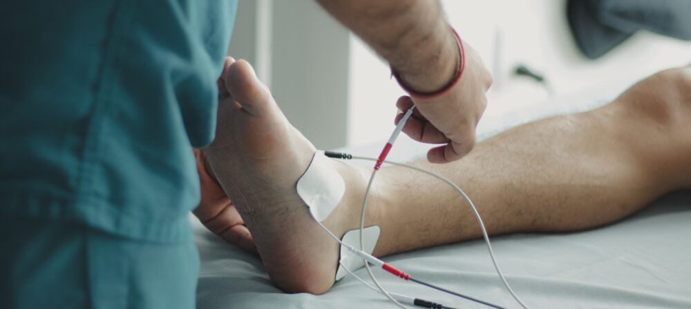 Professional podiatrist providing foot pain treatment in Blackburn clinic